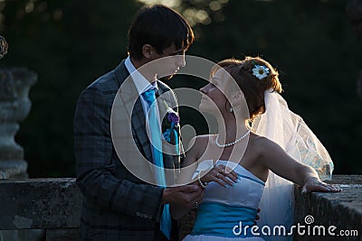 Happy couple hugging and smiling each other on background sunset Stock Photo