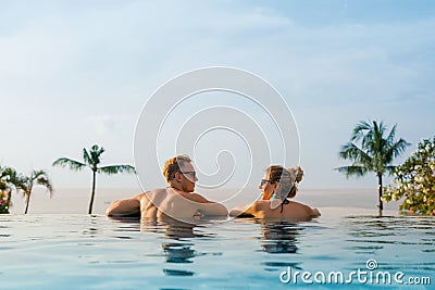 Happy couple in infinity pool Stock Photo