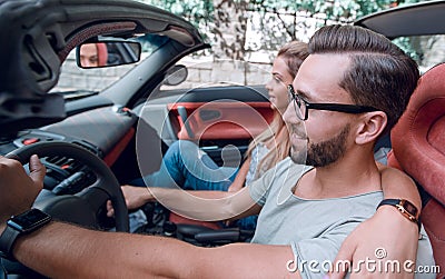 Happy couple inside convertible car in day trip Stock Photo