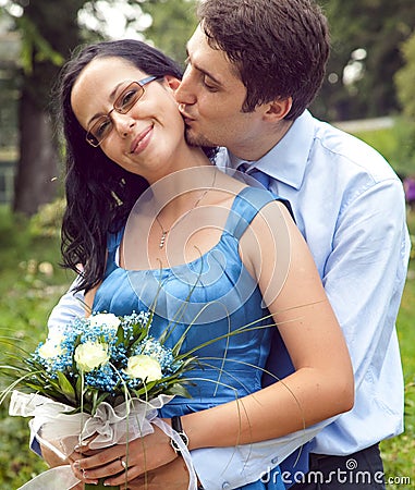 Happy couple in a kiss and hug romantic moment Stock Photo