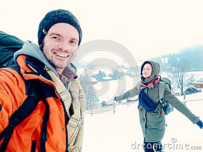 Happy couple laughing outdoors in winter mountain Stock Photo