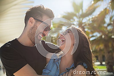 Happy couple laughing together standing outside Stock Photo