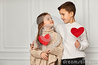 Happy couple little girl and boy with red hearts Stock Photo
