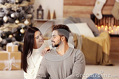 Happy couple in living room decorated for Christmas Stock Photo