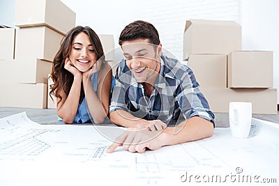 Happy couple looking at new house blueprints Stock Photo