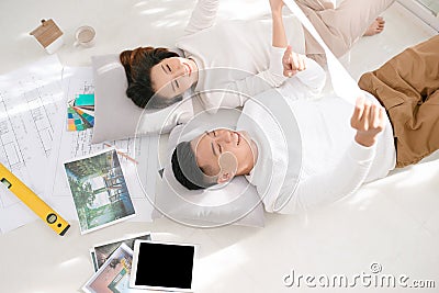 Happy couple looking at new house blueprints at home Stock Photo