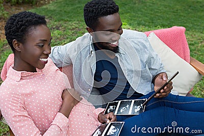 Couple looking at sonography in park Stock Photo