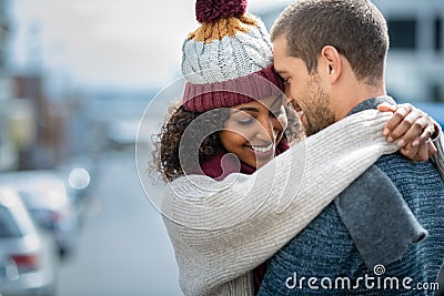 Happy couple in love embracing in winter Stock Photo