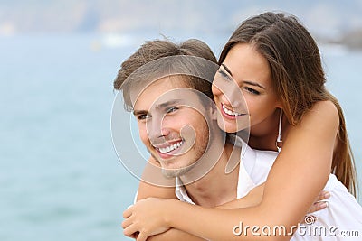 Happy couple in love with perfect smile on the beach Stock Photo