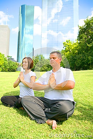 Happy Couple Meditate In Downtown Setting Stock Photo