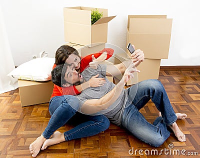 Happy couple moving together in a new house taking selfie video and pic Stock Photo