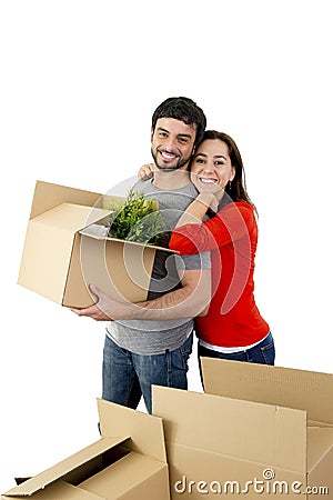 Happy couple moving together in a new house unpacking cardboard boxes Stock Photo