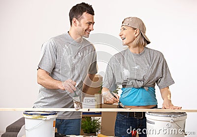 Happy couple at new home having fun painting Stock Photo