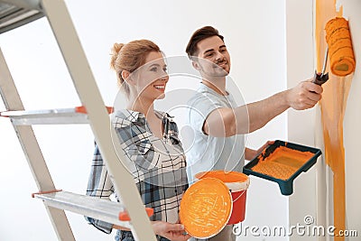 Happy couple painting wall. Home repair Stock Photo