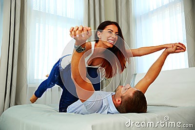 Happy couple playing on the bed Stock Photo