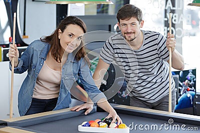 Happy couple playing billard Stock Photo