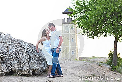 Happy couple posing on a summer day under a tree Stock Photo