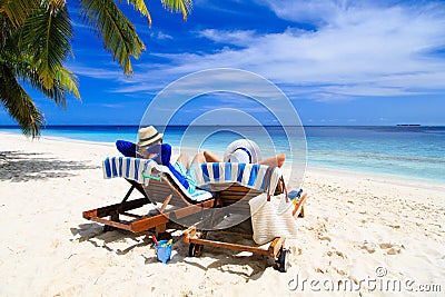 Happy couple relax on a tropical beach Stock Photo