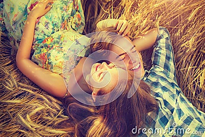 Happy couple relaxing outdoors on wheat field Stock Photo