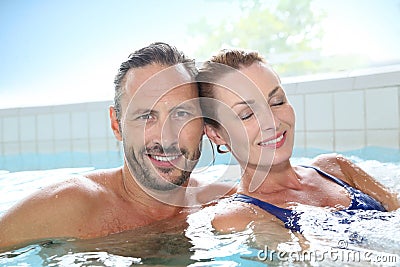 Happy couple relaxing in spa hot tub Stock Photo