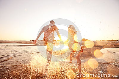 Couple running on the beach Stock Photo