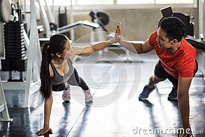 Happy couple sit up in gym Stock Photo