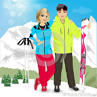 Happy couple skiers standing on edge of mountain peaks Stock Photo