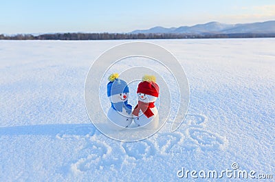 Happy couple of snowman in love standing on the snow. Writings 2019. Landscape with mountains in the cold winter day. Stock Photo