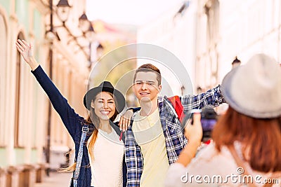 Happy couple stand close and girl shooting them Stock Photo