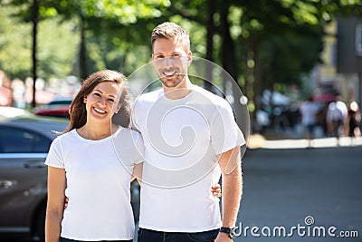 Happy Couple Standing On Street Stock Photo