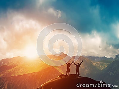 A happy couple standing together on a mountain Stock Photo