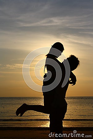 Happy Couple On Sunset Beach - Silhouette Royalty Free 