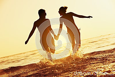 Happy couple sunset sea run Stock Photo