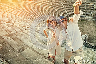 Happy couple take a selfie photo on the steps of antique ruins Stock Photo