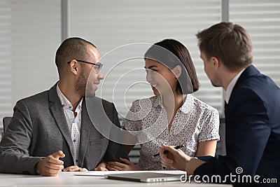 Happy couple talk making decision at realtor office Stock Photo