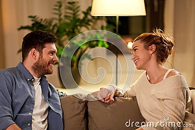 Happy couple talking at home in evening Stock Photo