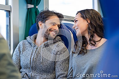 Happy couple traveling by train Stock Photo