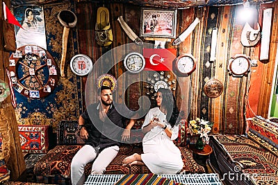 Happy couple in Turkey. Man and woman in the Eastern country. A couple in love travels. Happy couple having tea. Turkish hospitali Editorial Stock Photo