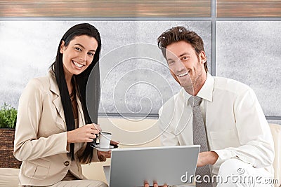 Happy couple using laptop at home smiling Stock Photo