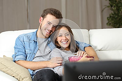 Happy couple watching movie on tv Stock Photo