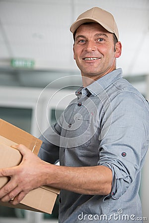 happy courier man with holding boxes Stock Photo