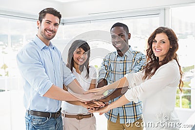 Happy coworkers joining hands in a circle Stock Photo
