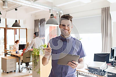 Happy creative male office worker with tablet pc Stock Photo