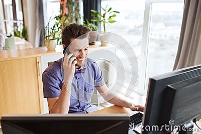 Happy creative male worker calling on smarphone Stock Photo