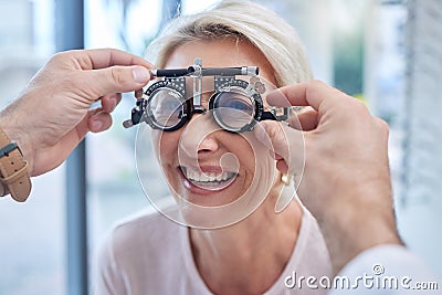 Happy customer in a vision test or eye exam for eyesight by doctor, optometrist or ophthalmologist with medical aid Stock Photo