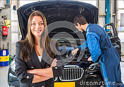 Happy customer, waiting for a mechanic to fix her car Stock Photo