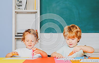 Happy cute clever boys pupils drawing. Kids funny education. Preschool childrenhaving fun in classroom. Kids ready for Stock Photo