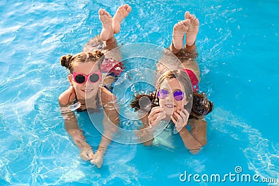 Happy cute girls in swimming pool Stock Photo