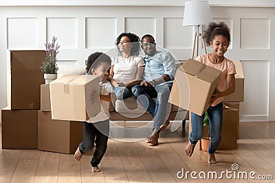 Happy little african kids holding boxes play on moving day Stock Photo