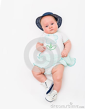 Happy cute 4 months old smiling baby in jeans hat on a white background. Stock Photo